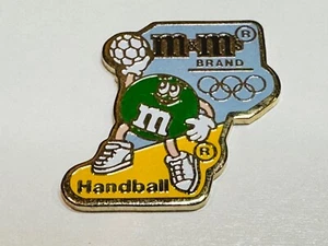 1992 Summer Olympic XXV Lapel Vest Hat Pin Barcelona Ms. Green M&M Mars Handball - Picture 1 of 2