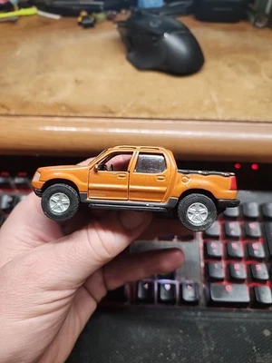 Maisto 1:47 Scale Diecast Ford Explorer Sport Trac Orange Pull Back Loose - Image 1 of 4
