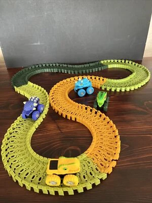 Dinosaur Jurassic Monster Trucks Multi Color Adjustable Click Tracks Play Magic - Image 1 of 4