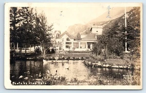 Postcard Boy in Canoe by Pullen House in Skagway Alaska RPPC photo by Olaf Dale - Picture 1 of 2