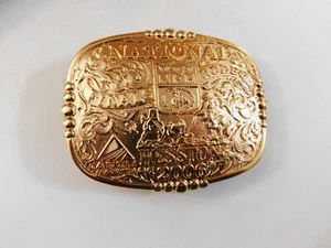 2006 MONTANA SILVERSMITH HESSTON NATIONAL FINALS RODEO BELT BUCKLE GOLD TONE - Picture 1 of 2