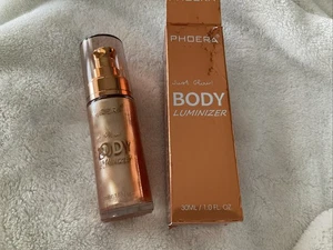 PHOERA Luminizador Corporal Alto Brillo, (Oro Rosa 101), Caja Bomba 1 Oz/30 Ml Dañada - Imagen 1 de 9