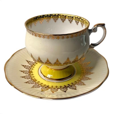 JUEGO DE TAZA Y PLATILLO DE TÉ ROSINA con patas de oro amarillo Inglaterra años 40 porcelana de hueso fino de colección Foto 1 de 4
