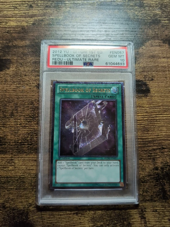 YUGIOH 1ST ED REDU-EN057 SPELLBOOK OF SECRETS ULTIMATE RARE PSA 10 Gem Mint  - Image 1 of 2