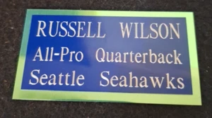 RUSSELL WILSON 1.75 x 3.25 inch BLUE Aluminum on GREEN Name Plate w/Adhe. Tape - Picture 1 of 2