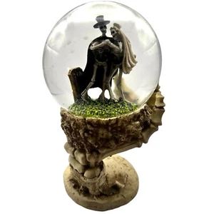 Skeleton Bride and Groom On Grave Snow Globe In Palm Of Skeleton Hand - Picture 1 of 5