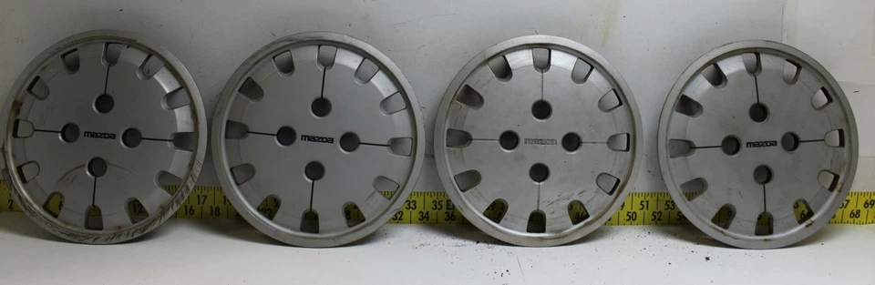 Juego de 4 tapacubos usados OEM G12037170 1986-1987 Mazda 626 363 (3345) Foto 1 de 4