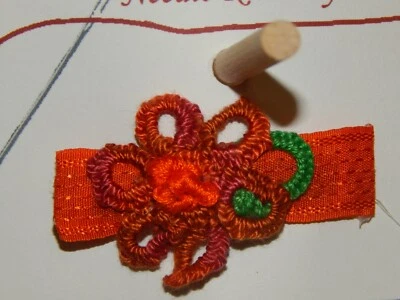 Handmade multi-shade orange tatted flower on orange 2" French barrette.  - Image 1 of 2