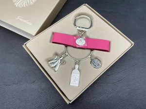 Guerlain Bijou de sac, Porte clés Charme en métal argenté avec nœud rose. - Photo 1/6