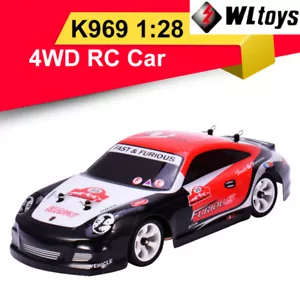 Wltoys K969 RC Auto 1:28 Quattro Ruote 4WD Fuoristrada 2.4G 30km Bambini Bambini Giocattoli - Foto 1 di 12