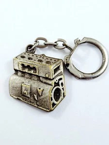 SCHLÜSSELANHÄNGER - MOTOR 2D Metall - FEMENIA Oran Bel-Abbes ALGERIEN Vintage Garage 60er - Bild 1 von 2