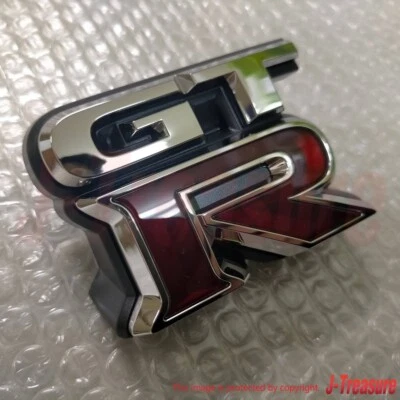 NISSAN GT-R GTR R35 2009-2023 Original Frontal "GT-R" Emblema Insignia 62892-JF60A OEM Foto 1 de 4