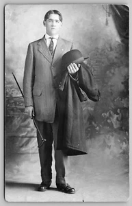 1910s RPPC Handsome Young Man in Suit & Tie Holding Hat Overcoat Postcard L9 - Picture 1 of 2