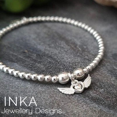 Pulsera de plata de ley 925 con corazón de ala 925 apilador de cuentas elásticas de INKA Foto 1 de 4