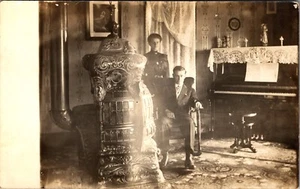 Victorian Couple Home Interior The Biermanns Potbelly Stove Piano Vintage RPPC - Picture 1 of 2