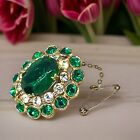 Edwardian green crystal oval shaped gold plated brooch with safety chain
