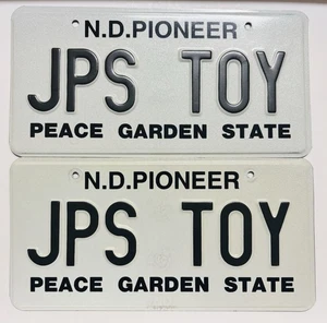 Vintage North Dakota Pioneer Auto License Plate Set Peace Garden State Embossed - Picture 1 of 2