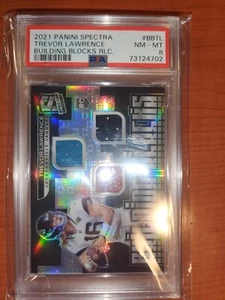 2021 SPECTRA BUILDING BLOCKS TREVOR LAWRENCE JERSEY/BALL ROOKIE CARD 37/99 PSA 8 - Picture 1 of 2