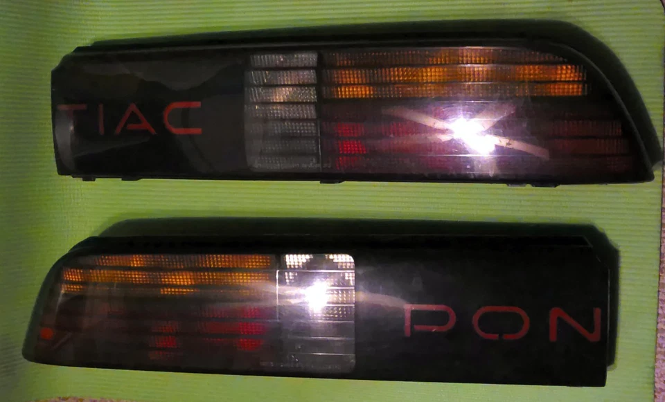 86-88 Pontiac Fiero GT OEM Rear Tail Light Assemblies with Mounting Bolts & Caps - Image 1 of 4