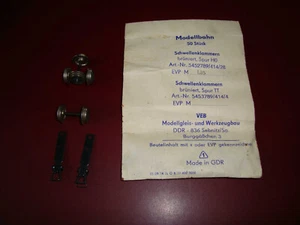 H0 Eisenbahn - 50x alte DDR-Schwellenklammern, 3x Metallräder und Kupplungen - Bild 1 von 1