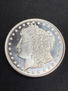 1 oz. Ronda de plata Highland Mint - diseño de dólar Morgan .999 fino - Imagen 1 de 2