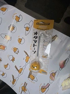 OTAMATONE GUDETAMA DAS FAULE EI ELEKTRONISCHES MUSIKINSTRUMENT NEU & POSTER - Bild 1 von 7
