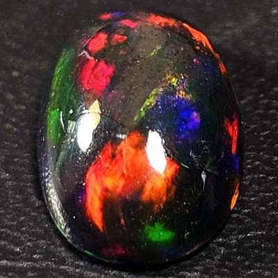 NATURAL AAA+BEAUTIFUL COLORPLAY OVAL CABOCHAN  ETHIOPIAN WELO BLACK OPAL 1.30CTS - Image 1 of 3