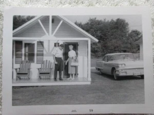1958 Oldsmobile, Couple Standing On Cottage Porch Photograph, July 1959 - Picture 1 of 3