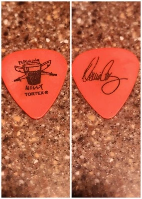 Flogging Molly Tour used black on Orange Dennis Casey band logo Guitar Pick Pic - Image 1 of 3