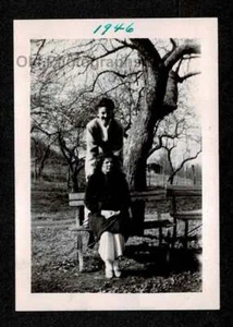 WOMAN STANDING OVER GIRLFRIENDS PARK BENCH 1946 OLD/VINTAGE PHOTO SNAPSHOT- D162 - Picture 1 of 1
