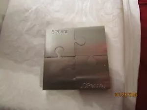 Peso de papel rompecabezas de acero inoxidable JC Penney 5 años - Imagen 1 de 9