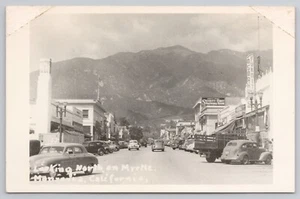 RPPC 1940s MONROVIA CA Myrtle Ave, San Gabriel Mountains, signs cars bank flag - Picture 1 of 4