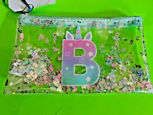 Just Shine Justice durchsichtiges Etui mit Reißverschluss "B" - Bild 1 von 3
