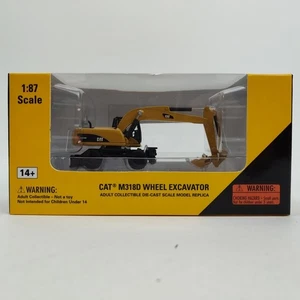 Escavatore gommato NORSCOT Caterpillar CAT scala 1:87 HO M318D 55177 modello pressofuso - Foto 1 di 15