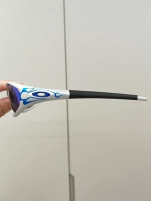 Jaqueta Reta Oakley 99 Muzm OO9505 Armação Prata/Lentes Azuis Nova - Imagem 1 de 4