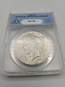 1923 S Peace Dollar Silver Struck Thru Fragment ANACS AU 50 - Picture 1 of 3