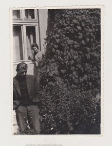 Young Man with Hands in Pockets Admired by a Beautiful Woman Behind Him Snapshot - Picture 1 of 7