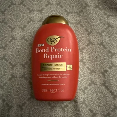 Acondicionador reparador de proteínas OGX Bond 13 fl oz para reparar y proteger el cabello dañado Foto 1 de 2