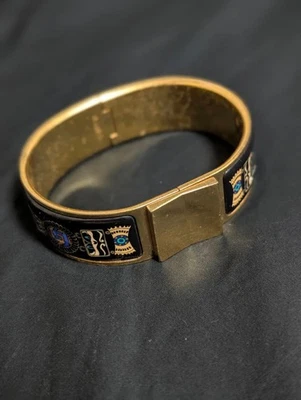 Pulsera decorativa HERMES metal esmalte negro y dorado usada Foto 1 de 4