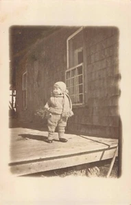 RPPC Child in Winter like attire on porch #1 - Picture 1 of 2