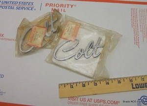 NOS Mopar 1974-1979 Dodge COLT fender side nameplates PAIR  CHROME   pn MB028718 - Bild 1 von 4