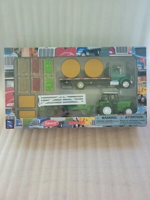 New Ray Green Peterbilt 335 Flat bed Semi Truck w/ Farm Tractor & Trailer & Hay - Image 1 of 4