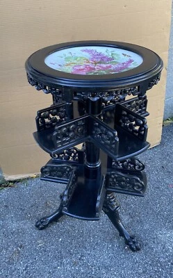 BLACK LACQUERED REVOLVING BOOKSTAND WITH PAINTED PORCELAIN TOP - Image 1 of 4