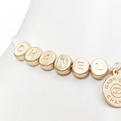 CHANEL white gold tone logo letter bead charm white thread lucky bracelet - Image 1 of 4