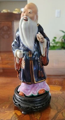 Chinese Shou Famille Rose Statue On Carved Wood Stand 7" Smiling Immortal As Is - Image 1 of 4