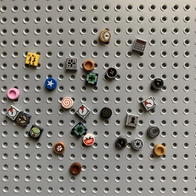 Lego lot of 26 pieces of 1x1 tiles square and round with printed decorations - Image 1 of 3