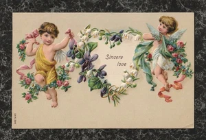 1910 geprägte Valentinspostkarte mit zwei Cherubs Bändern & Blumen KV Stempel - Bild 1 von 2