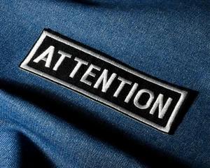 Attention Iron-On Patch – 11 x 3.5cm Bold Black & White Embroidered Banner Patch - Picture 1 of 4