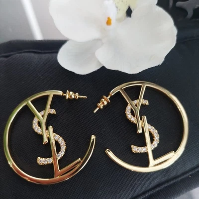 Auténtico. PENDIENTES ARO CRISTAL LOGO YVES SAINT LAURENT YSL TONO DORADO Foto 1 de 4