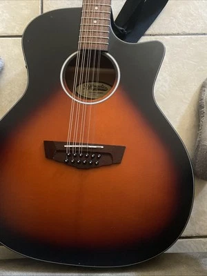 Guitarra acústica D Angelico usada con capo blanco y correa para el cuello Foto 1 de 4